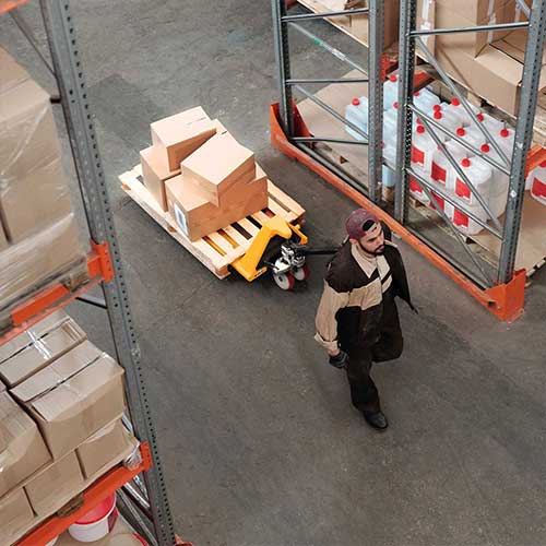 Pallet truck with hard nylon wheels and rollers